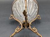 an image of a glass bowl on a stand on a gray surface