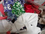 a suitcase full of clothes and clothes sitting on the floor