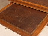two wooden tables with a leather top on top of each other
