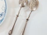 two spoons and a plate on the table
