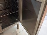 a small oven with a door open in a kitchen