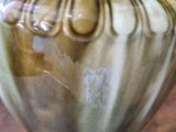 a vase that is sitting on a table with a flower in it