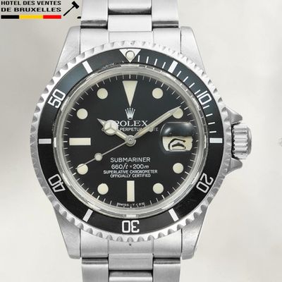 a close up of a watch with a black dial on a bracelet