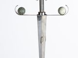a metal sculpture of an angel with wings on a stand