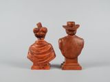 pair of carved wooden busts of a man and a woman