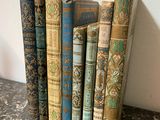 several old books are stacked on top of each other on a table