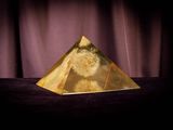 an image of a golden pyramid sitting on top of a table