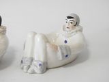 two salt and pepper shakers sitting next to each other