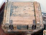 an old wooden trunk sitting on the floor next to a pair of shoes