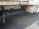 a close up of a truck ' s exhaust pipe on the side of the road