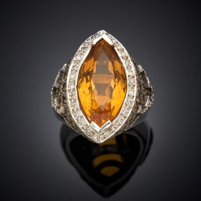 an orange sapphire and diamond ring