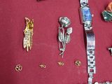 a lot of jewelry on a red surface