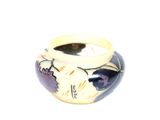 a white vase with a blue and purple design on it