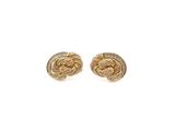 a pair of gold tone earrings with a knot design