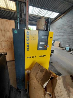 a machine that is sitting in a warehouse next to a pile of boxes