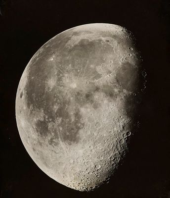 an old black and white photo of the moon in the dark sky