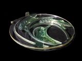a picture of a green glass broochle on a black background