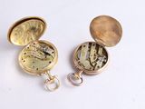 a gold pocket watch with a chain attached to it