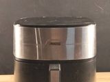 a silver and black speaker on a wooden table