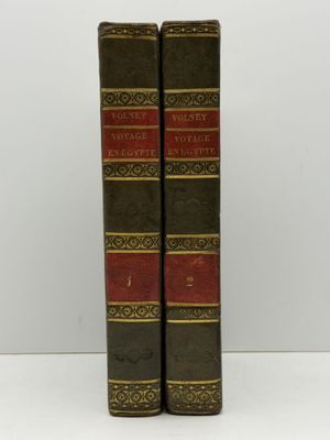 a pair of books sitting on top of each other on a table