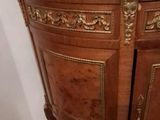 a wooden cabinet with a mirror on top of it