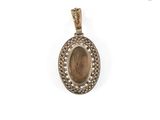 a gold pendant with a picture of a woman on it