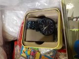 a box with a watch and other items in it
