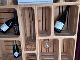 a wine rack with wine bottles and wine glasses on it
