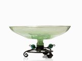 a green glass bowl on a metal stand on a white background