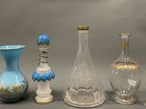 several glass vases and vases are lined up on a gray surface