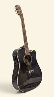 une image représentant une guitare acoustique noire posée sur une surface blanche