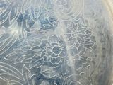 a close up of a silver plate with designs on it