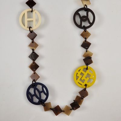 a close up of a necklace with a peace sign on it