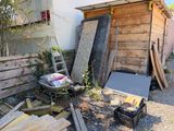 a pile of junk outside of a wooden building