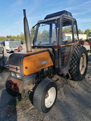 a tractor that is parked in the dirt