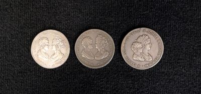 three different types of coins on a black surface