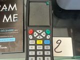 a remote control sitting on a glass table next to a book