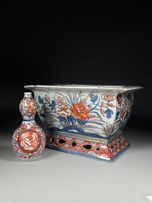 two vases and a vase on a table with a black background