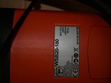 a close up of a red and black electric device