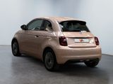 the small car is parked in the large room of the building