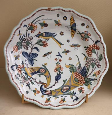 a plate with a bird and flowers design on it