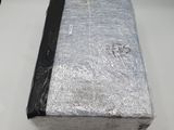 a box that is wrapped in foil and sitting on a table