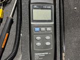 a black case with a digital thermometer inside of it