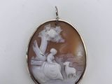 a close up of a pendant with a picture of a man and a woman