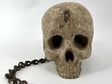 a skull that is chained to a chain on a white background