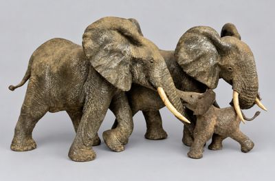 three elephants that are standing next to each other