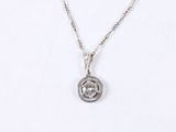a close up of a necklace on a white surface