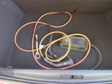 wires in the trunk of a car that is connected to a charger
