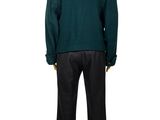 the back view of a mannequin wearing a green sweater and black pants