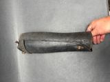 a hand that is holding a piece of leather